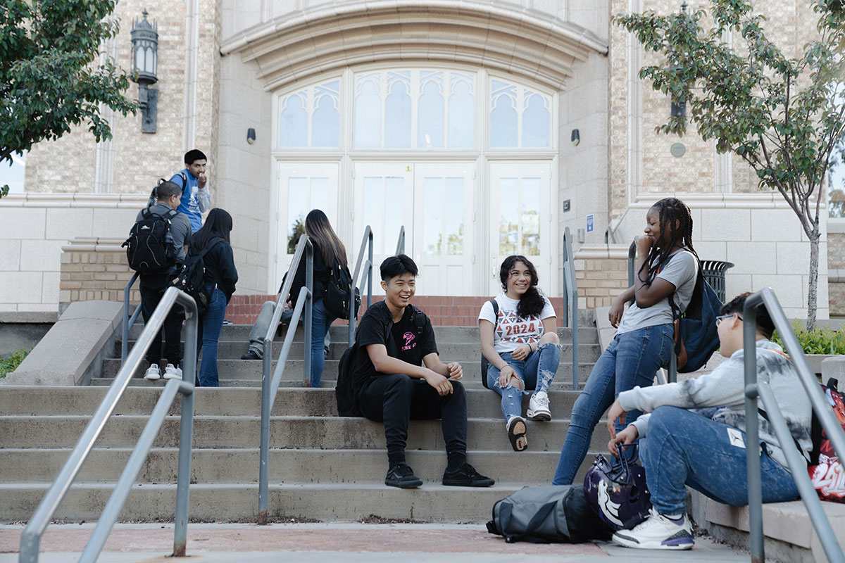 DPS Students sitting on steps laughing